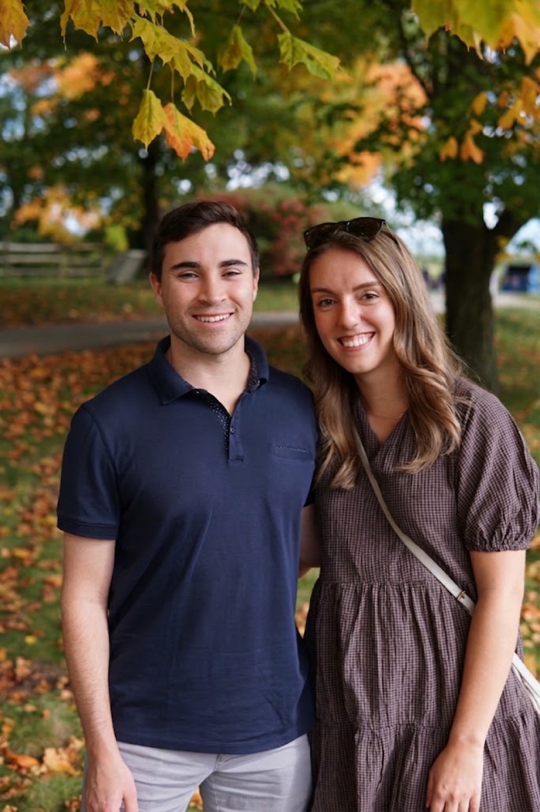 Caitlin and Paul smiling together outdoors in fall