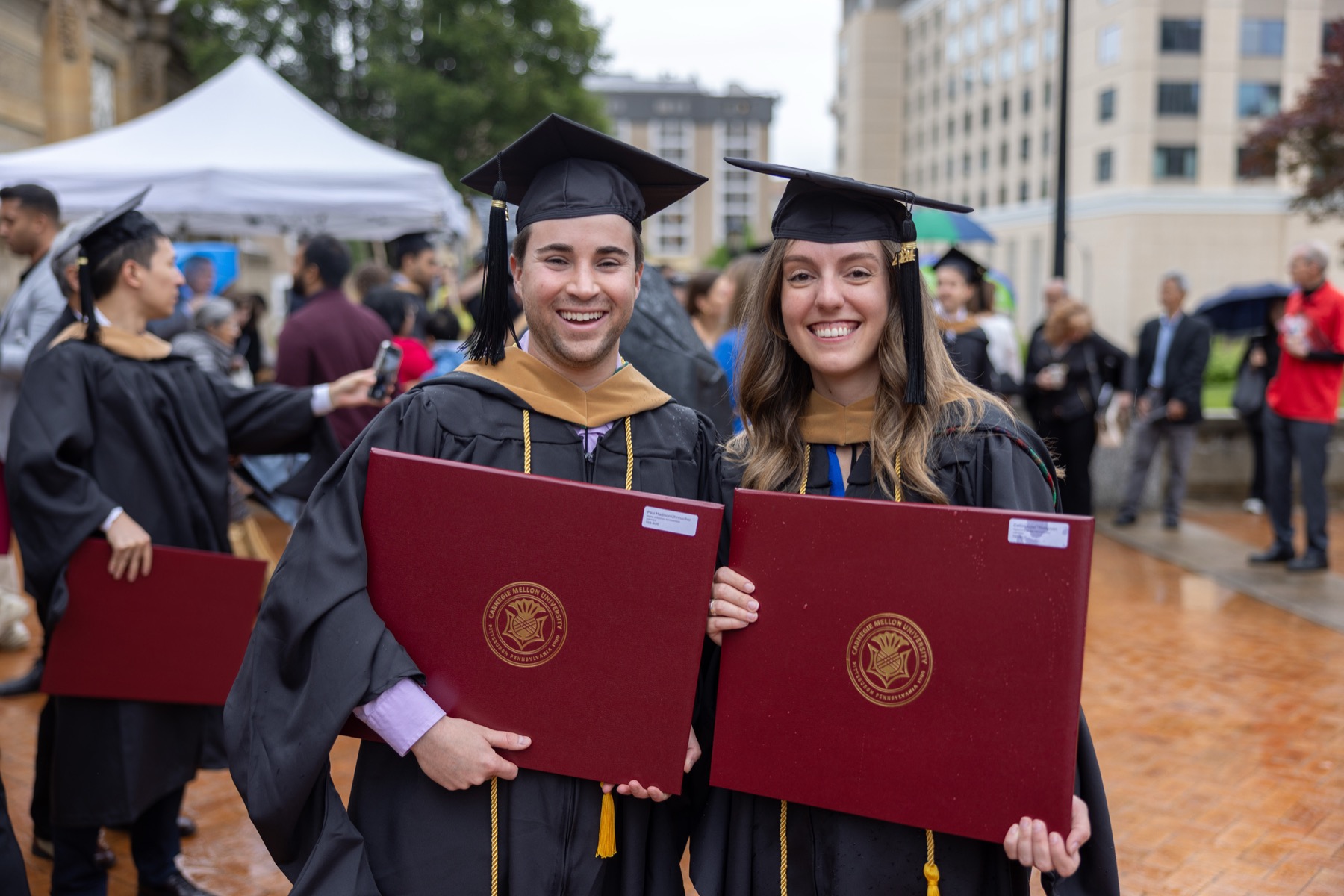 Caitlin and Paul at Carnegie Mellon graduation, holding their diplomas